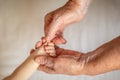 Grandmother holds the hand of her newborn grandson. the concept of protection and care of the new generation Royalty Free Stock Photo