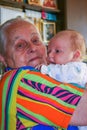 Grandmother holds her own grandson. Happy family.