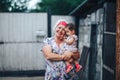 Grandmother Hugging granddaughter In nature in sunny summer day Royalty Free Stock Photo