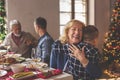 Grandmother hugging grandson while having Christmas dinner