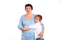 Grandmother hugging her grandson on a white background Royalty Free Stock Photo