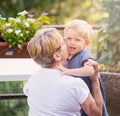 Grandmother and grandchild kisses in garden Royalty Free Stock Photo