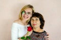 grandmother hugs her adult granddaughter. Young woman carefully hugs an older woman. Family portrait Royalty Free Stock Photo