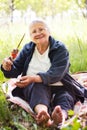 Grandmother with kebab in hand Royalty Free Stock Photo