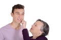 Grandmother kissing her teen grandson on the cheek Royalty Free Stock Photo