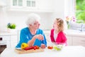 Grandmother and little girl making salad Royalty Free Stock Photo