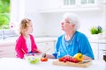 Grandmother and little girl making salad Royalty Free Stock Photo