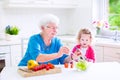 Grandmother and little girl making salad Royalty Free Stock Photo