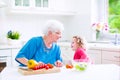 Grandmother and little girl making salad Royalty Free Stock Photo