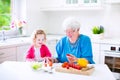 Grandmother and little girl making salad Royalty Free Stock Photo