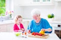 Grandmother and little girl making salad Royalty Free Stock Photo