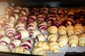 Grandmother making handmade tasty butter rolling cookies with fruit and berry jam on oven tray before baking at kitchen Royalty Free Stock Photo