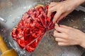 Grandmother making handmade tasty butter rolling cookies with fruit and berry jam on oven tray before baking at kitchen Royalty Free Stock Photo