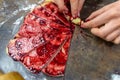 Grandmother making handmade tasty butter rolling cookies with fruit and berry jam on oven tray before baking at kitchen Royalty Free Stock Photo