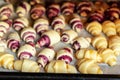 Grandmother making handmade tasty butter rolling cookies with fruit and berry jam on oven tray before baking at kitchen Royalty Free Stock Photo