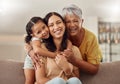 Grandmother, mom and child hug in a portrait for mothers day on a house sofa as a happy family in Colombia. Smile, mama Royalty Free Stock Photo