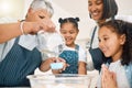 Grandmother, mom or happy children baking in kitchen as a happy family with siblings learning cookies recipe. Mixing Royalty Free Stock Photo