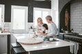 Grandmother, mother and child baking in the kitchen together while bonding in the family home. Senior woman, mom and