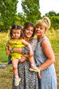 Grandmother, Mother And Daughter Relaxing In Park. Three generations are playing together in the garden Royalty Free Stock Photo