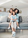 Grandmother, mother and girl on sofa for portrait in living room, home or happy together for a hug or quality time in Royalty Free Stock Photo