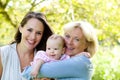 Grandmother and mother smiling with baby