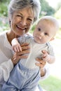 Grandmother outdoors on patio with baby Royalty Free Stock Photo