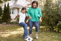Grandmother Playing Soccer In Garden With Granddaughter Royalty Free Stock Photo