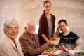 Grandmother, portrait and family at dinner on Christmas, together with food and celebration in home. Happy, event and Royalty Free Stock Photo