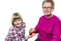 Grandmother putting euro coin in piggy bank of granddaughter Royalty Free Stock Photo