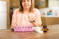 Grandmother putting tablets on a pill box Royalty Free Stock Photo