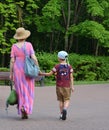 Grandmother and grandson walk in the green summer park in the Minsk Belarus Royalty Free Stock Photo