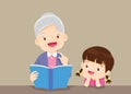 The grandmother reading book for the grandchildren on the table to enjoy. Royalty Free Stock Photo
