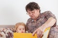 Grandmother reads an interesting book for her grandson