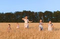 Grandmother running after kids in field