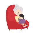 grandmother sits in a chair and reads a book to her granddaughter Royalty Free Stock Photo