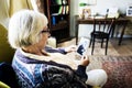 Grandmother sitting and looking at her husband`s photo Royalty Free Stock Photo