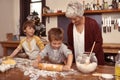 Grandmother, smile and kids baking in kitchen, learning or happy boys bonding together in home. Grandma, children and Royalty Free Stock Photo