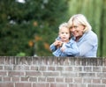 Grandmother smiling with baby girl outdoors Royalty Free Stock Photo