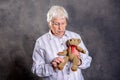 Grandmother with stethoscope is puppet doctor for teddy bear Royalty Free Stock Photo