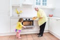 Grandmother and sweet girl baking pie in white kitchen Royalty Free Stock Photo
