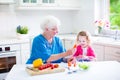 Grandmother and sweet girl making salad Royalty Free Stock Photo