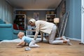 Grandmother taking care of her grandchild while his parents working. Senior woman work as a nanny, playing with young baby on the