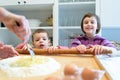 Grandmother teaches her grandchildren how to make pasta