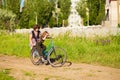 Grandmother teaches little granddaughter to ride bike