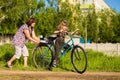 Grandmother teaches little granddaughter to ride bike