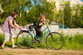 Grandmother teaches little granddaughter to ride bike