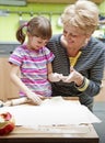 Grandmother teaching her granddaughter cooking