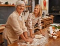 Learning grandmas secret recipes. A grandmother teaching her granddaughter how to bake. Royalty Free Stock Photo