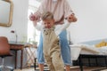 Grandmother teaching her little grandson to walk. Royalty Free Stock Photo