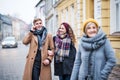 Grandmother and teenage grandchildren walking down the street in winter. Royalty Free Stock Photo